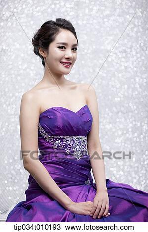 close up of a woman in purple dress posing gracefully View Large Photo Image Stock Image - close up of a woman in purple dress posing gracefully . Fotosearch