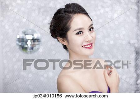 Stock Photograph - close up of a woman in purple dress posing gracefully . Fotosearch