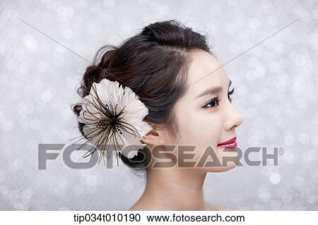 close up of a woman with flower in the head posing gracefully View Large Photo Image Stock Image - close up of a woman with flower in the head posing gracefully . Fotosearch