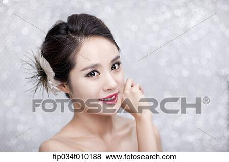 close up of a woman with flower in the head posing gracefully View Large Photo Image Stock Photo - close up of a woman with flower in the head posing gracefully . Fotosearch