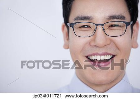 Stock Image - close up shot of a businessman smiling. Fotosearch