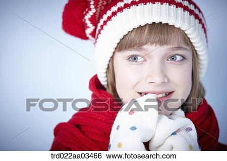 Stock Photograph - close up shot of a girl in winter outfit posing. Fotosearch