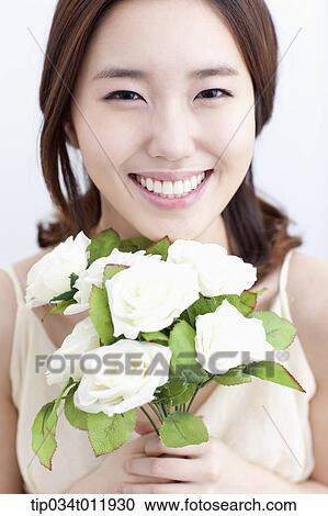 close up shot of a lady holding a bundle of flowers View Large Photo Image Stock Image - close up shot of a lady holding a bundle of flowers. Fotosearch