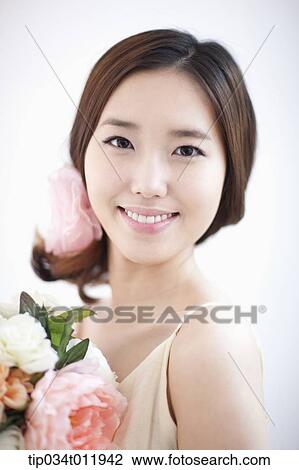 close up shot of a lady holding a bundle of flowers View Large Photo Image Stock Image - close up shot of a lady holding a bundle of flowers. Fotosearch