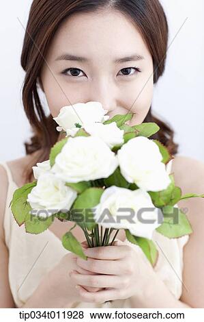 Stock Photo - close up shot of a lady holding a bundle of flowers. Fotosearch