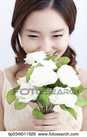 Stock Photograph - close up shot of a lady holding a bundle of flowers. Fotosearch