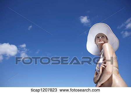 close up shot of a lady in bikini and beach hat View Large Photo Image Stock Image - close up shot of a lady in bikini and beach hat. Fotosearch