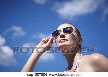 close up shot of a lady in sunglasses and bikini View Large Photo Image Picture - close up shot of a lady in sunglasses and bikini. Fotosearch