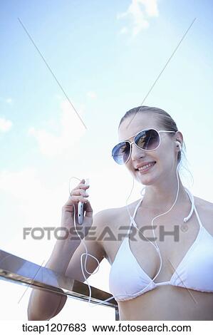 Stock Image - close up shot of a lady in sunglasses and bikini. Fotosearch
