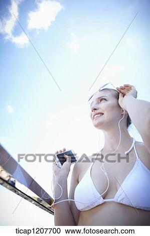 Stock Image - close up shot of a lady in sunglasses and bikini. Fotosearch