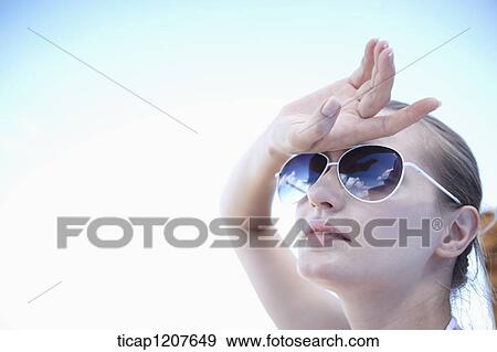 close up shot of a lady in sunglasses under the sun View Large Photo Image Stock Photo - close up shot of a lady in sunglasses under the sun. Fotosearch