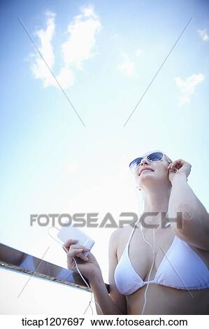 Stock Photo - close up shot of a lady in sunglasses and bikini. Fotosearch