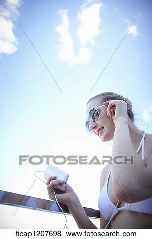 Stock Photo - close up shot of a lady in sunglasses and bikini. Fotosearch
