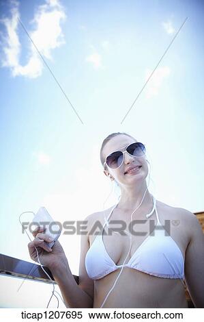 Stock Photography - close up shot of a lady in sunglasses and bikini. Fotosearch