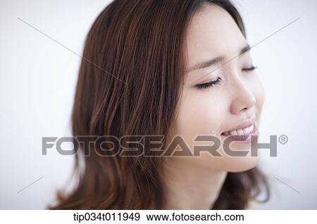Stock Photo - close up shot of a lady smiling while crying. Fotosearch