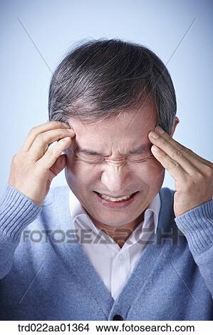 Picture - close up shot of a middle aged man frowning. Fotosearch
