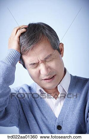 Stock Image - close up shot of a middle aged man frowning. Fotosearch