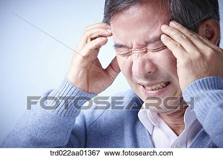 Stock Photo - close up shot of a middle aged man frowning. Fotosearch