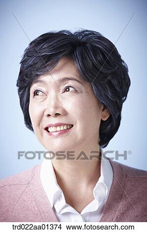 close up shot of a middle aged woman smiling View Large Photo Image Picture - close up shot of a middle aged woman smiling. Fotosearch