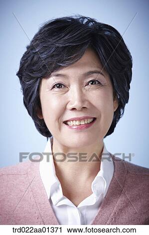 close up shot of a middle aged woman smiling View Large Photo Image Stock Image - close up shot of a middle aged woman smiling. Fotosearch