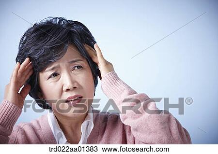 close up shot of a middle aged woman frowning View Large Photo Image Stock Image - close up shot of a middle aged woman frowning. Fotosearch