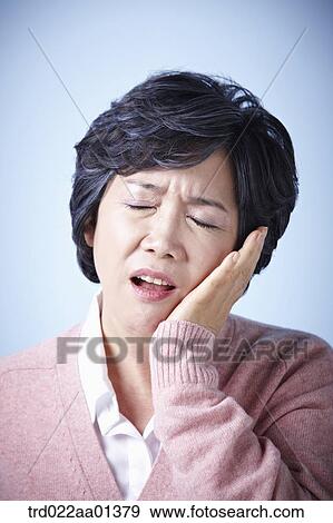 close up shot of a middle aged woman frowning View Large Photo Image Stock Photo - close up shot of a middle aged woman frowning. Fotosearch
