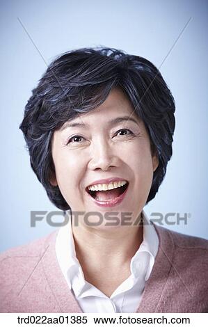 Stock Photography - close up shot of a middle aged woman laughing. Fotosearch