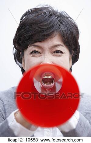 Stock Photo - close up shot of a mother scolding with megaphone. Fotosearch