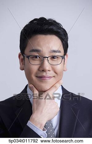 Stock Image - close up shot of businessman with glasses. Fotosearch