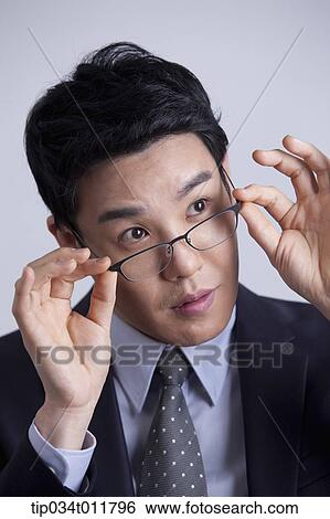 Stock Photograph - close up shot of businessman with glasses. Fotosearch