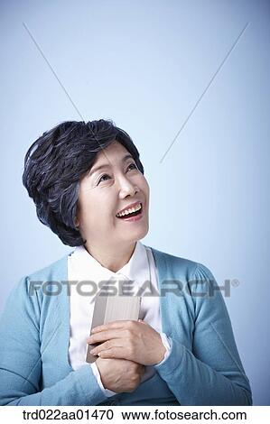 close up shot of happy middle aged woman with bankbook View Large Photo Image Stock Image - close up shot of happy middle aged woman with bankbook. Fotosearch