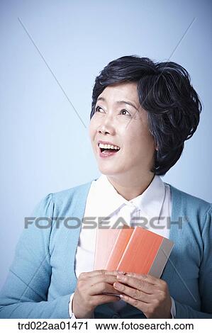 close up shot of happy middle aged woman with bankbooks View Large Photo Image Stock Image - close up shot of happy middle aged woman with bankbooks. Fotosearch