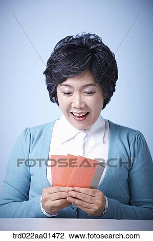 close up shot of happy middle aged woman with bankbooks View Large Photo Image Stock Image - close up shot of happy middle aged woman with bankbooks. Fotosearch