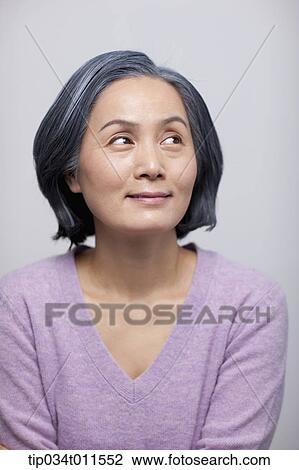 Stock Image - close up shot of middle aged woman smiling. Fotosearch