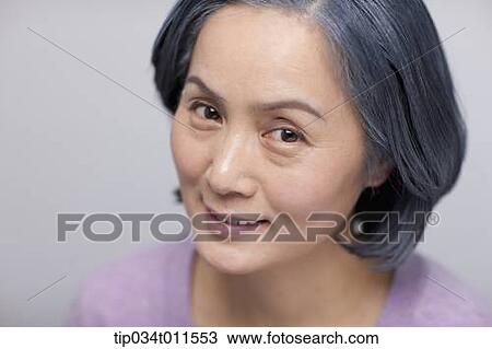 Stock Image - close up shot of middle aged woman smiling. Fotosearch