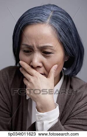 Stock Image - close up shot of middle aged woman crying. Fotosearch