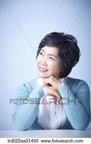 Stock Image - close up shot of middle aged woman smiling. Fotosearch