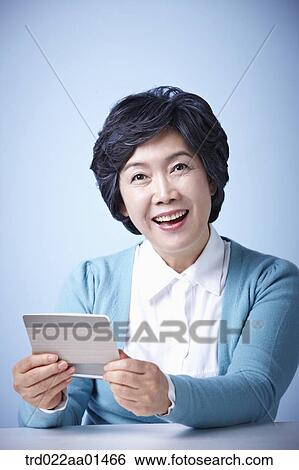 close up shot of middle aged woman happily opening bankbook View Large Photo Image Stock Photograph - close up shot of middle aged woman happily opening bankbook. Fotosearch