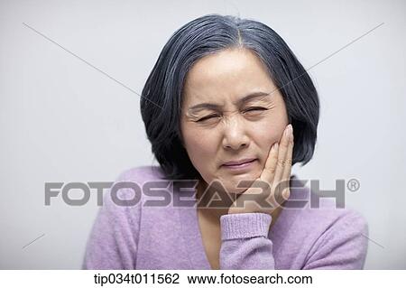 Stock Image - close up shot of middle aged woman with awful face. Fotosearch