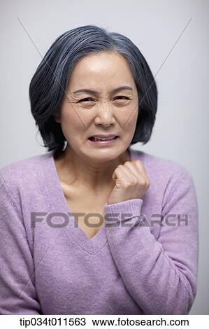 Stock Image - close up shot of middle aged woman with awful face. Fotosearch