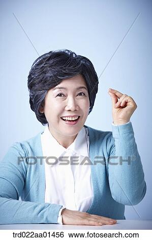 close up shot of middle aged woman with an idea View Large Photo Image Stock Photograph - close up shot of middle aged woman with an idea. Fotosearch