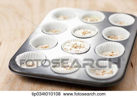 Stock Photo - cupcakes on oven tray. Fotosearch