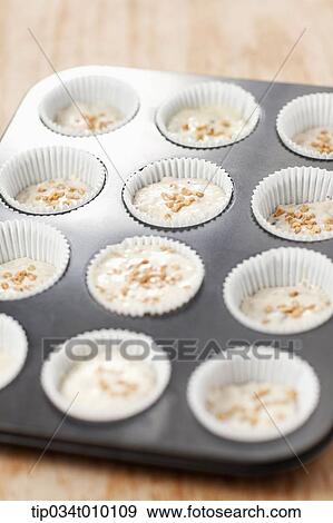Stock Photo - cupcakes on oven tray. Fotosearch