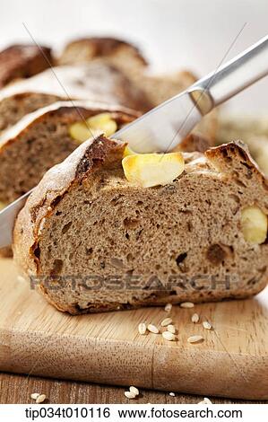 Stock Photograph - cut bread on a cutting board. Fotosearch