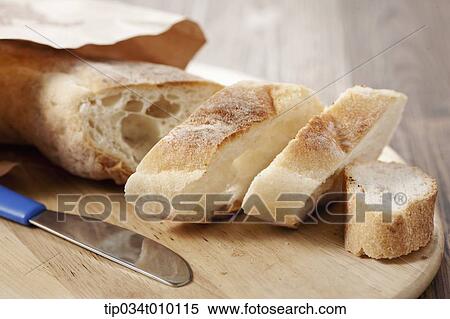 Stock Photography - cut bread on a cutting board. Fotosearch