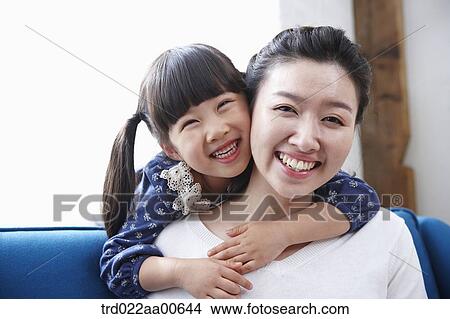 daughter hugging mother from behind View Large Photo Image Picture - daughter hugging mother from behind. Fotosearch