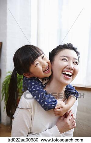 daughter hugging mother from behind View Large Photo Image Stock Image - daughter hugging mother from behind. Fotosearch