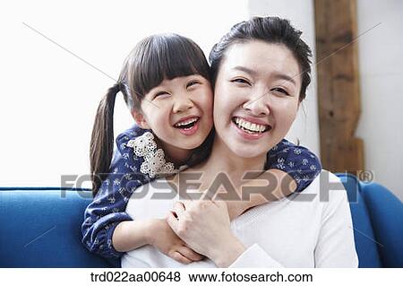 daughter hugging mother from behind View Large Photo Image Stock Photo - daughter hugging mother from behind. Fotosearch