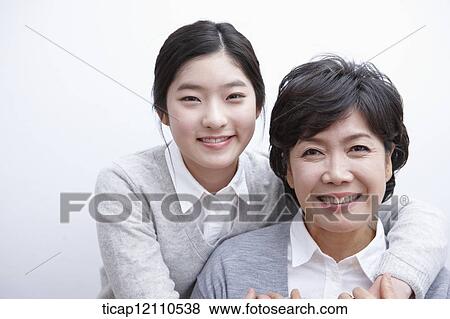 Stock Photo - daughter hugging mother. Fotosearch