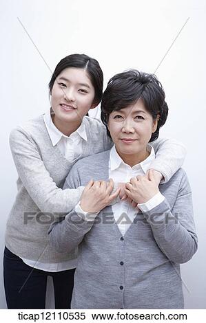 Stock Photography - daughter hugging mother. Fotosearch